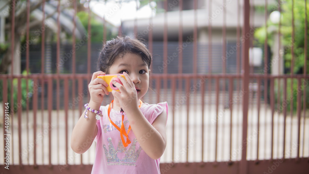 Beautiful little girl smiling and holding a camera. Beautiful little girl smiling and holding a camera.