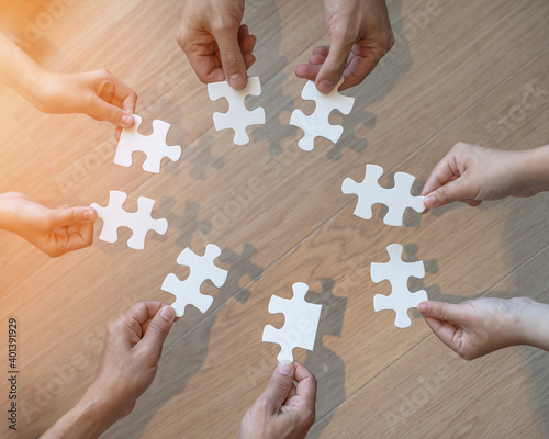 Teamwork idea brainstorming, team partnership connection for problem solving, finding solution in hope concept with puzzle jigsaw pieces in school children or student kids's hands