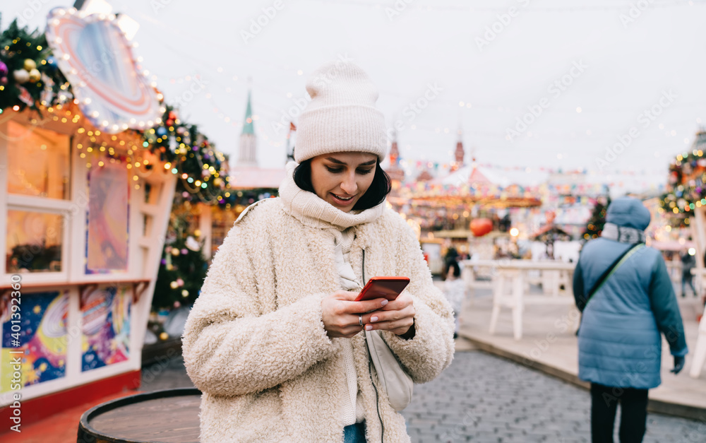 Content woman messaging on mobile phone during walk