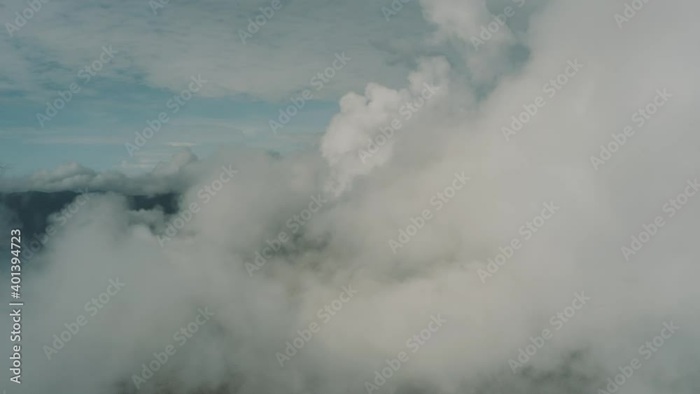Drone aerial flying next to puffy clouds, top landscape panoramic view Drone aerial flying next to puffy clouds, top landscape panoramic view
