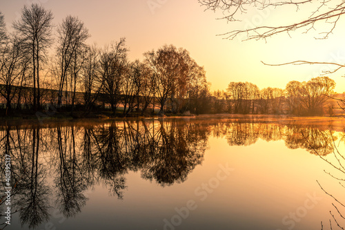 Fototapeta Naklejka Na Ścianę i Meble -  Super beautiful lake, with reflection in the water, nature, trees and a great landscape. Lots of plants and trees great clouds and colors for the sunrise