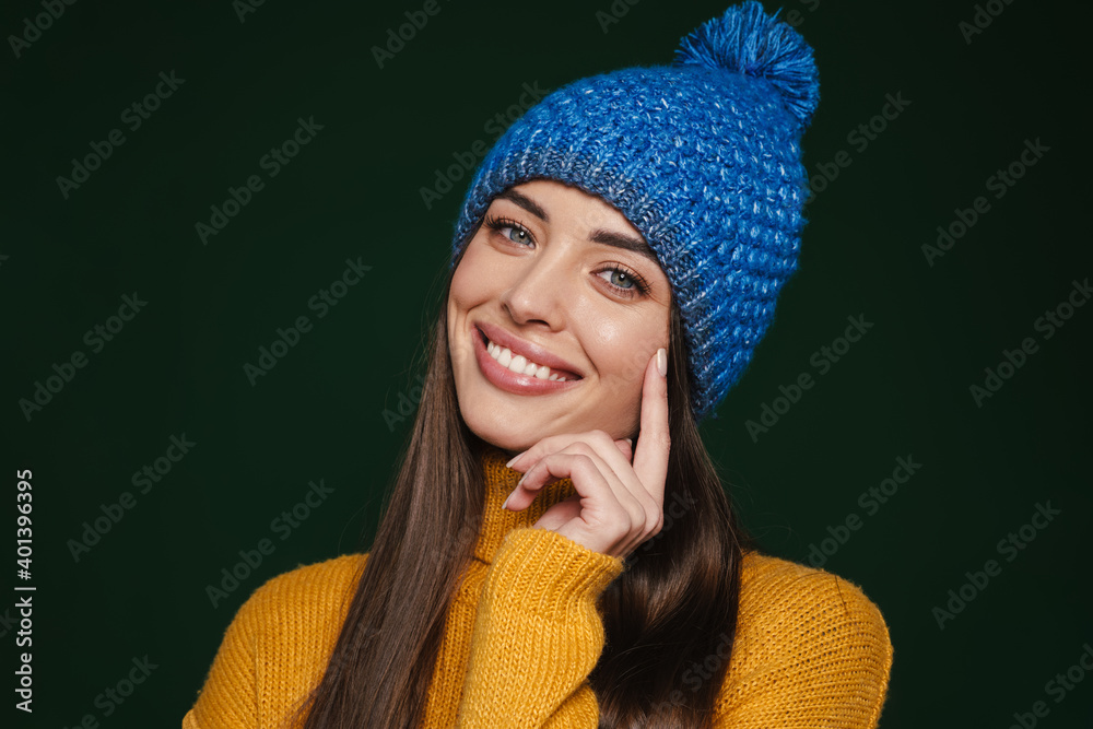 Joyful beautiful girl in knit hat smiling and looking at camera Joyful beautiful girl in knit hat smiling and looking at camera
