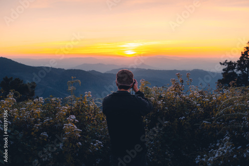 A photographer taking a picture of the sunset