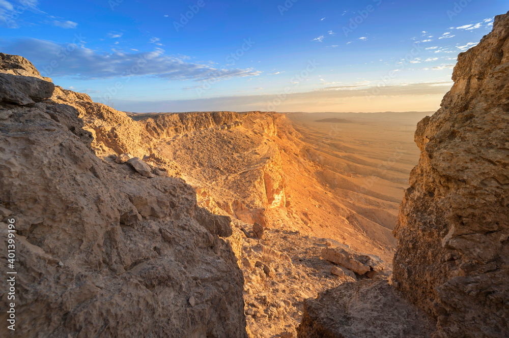 Beautiful landscape with sun light hitting the cliffs of Machtesh Ramon (Ramon Crater), Negev Desert, Israel