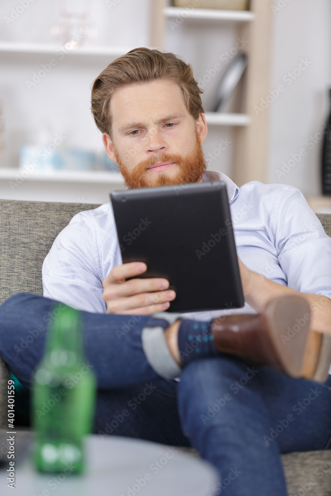 man with tablet home alone man with tablet home alone