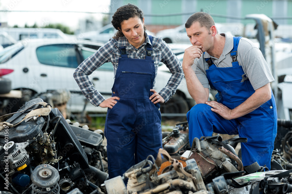 man and woman working on junkyard man and woman working on junkyard