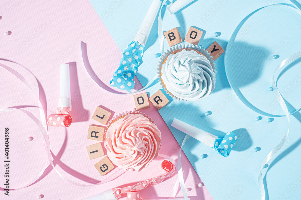 Fototapeta premium gender party. boy or girl. two cupcakes with blue and pink cream, celebration concept when the gender of the child becomes known