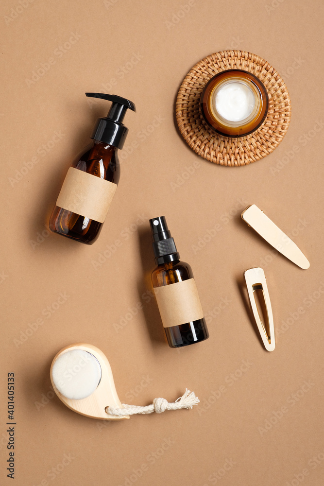 Set of natural cosmetics for skin care in amber glass packaging and female accessories on brown background. Natural beauty product for bathroom. Flat lay, top view. Set of natural cosmetics for skin care in amber glass packaging and female accessories on brown background. Natural beauty product for bathroom. Flat lay, top view.