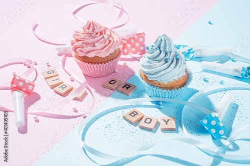 gender party. boy or girl. two cupcakes with blue and pink cream  celebration concept when the gender of the child becomes known