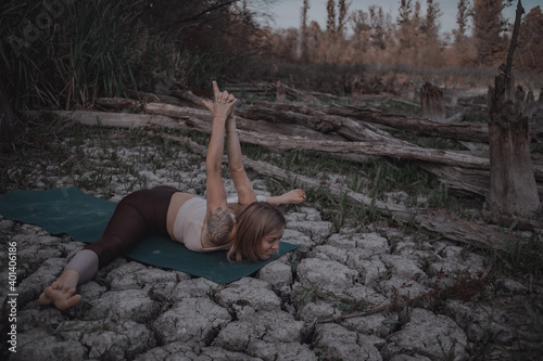 attractive blonde doing yoga outdoors in an unusual place