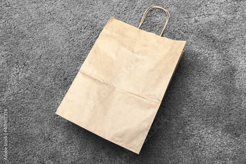 Recycling paper bag is on a gray carpet, top view