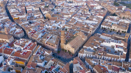 City centre of Antequera with typical Spanish church and white buildings seen from above, aerial view of Andalusian town © Pablo