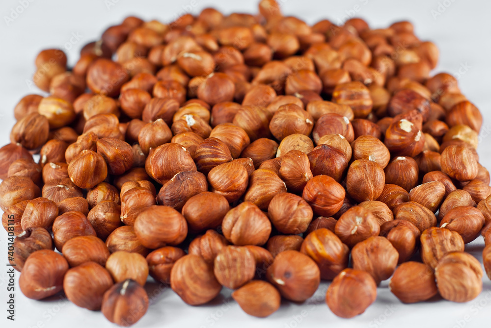 Peeled hazelnuts close up. Texture of nuts. Lots of nuts in a pile. Peeled hazelnuts close up. Texture of nuts. Lots of nuts in a pile.