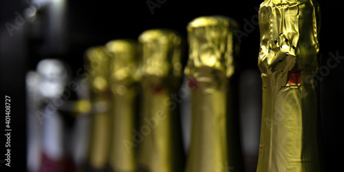 Large selection of champagne on store shelves. Traditional holidays and events. Close-up. Panorama format. photo
