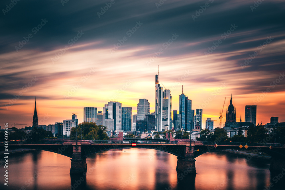 What a mood in the sky, sunset with incredible clouds and colors with a view over the Main. The Frankfurt skyline can be seen in the background. Shipping romance on the river in Germany