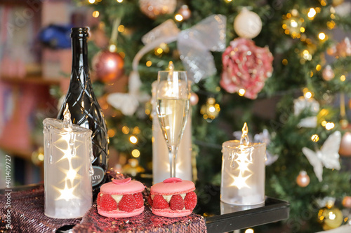 Fototapeta Naklejka Na Ścianę i Meble -  Three candles with stars, bottle of wine with glass of champagne, Christmas tree, xmas time decoration