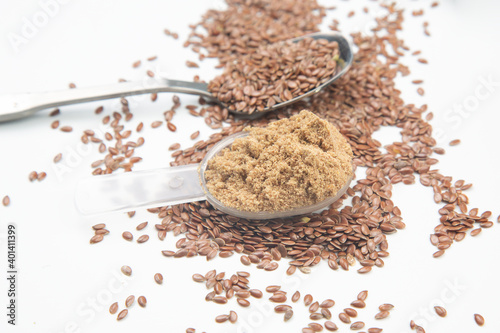 ground flaxseed on a white background. vitamins and healthy food