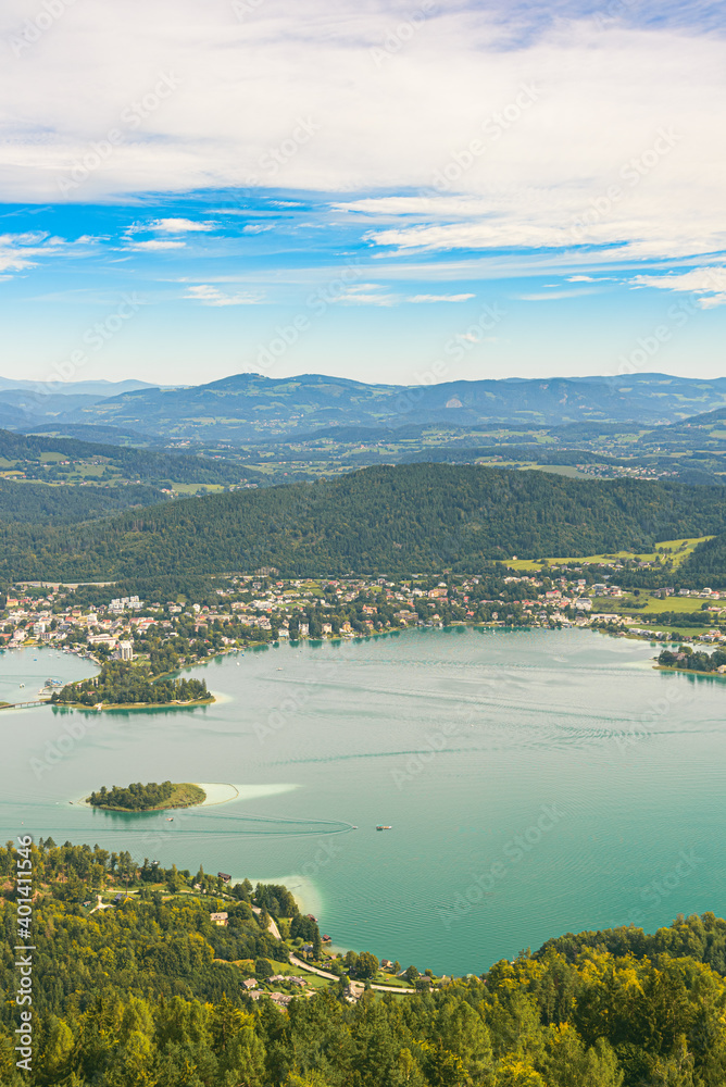 Fototapeta premium Panorama of Lake and mountains at Worthersee Carinthia Austria. View from Pyramidenkogel tower on lake and Klagenfurt the area.