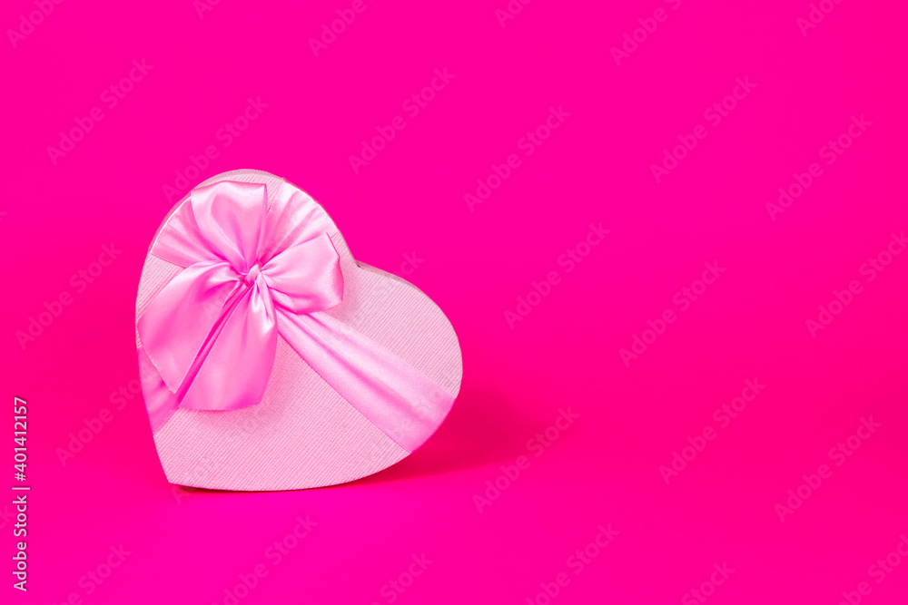 Valentine's Day holiday. Pink heart box with bow on pink background. Gift heart. Love and passion concept. Valentine's Day gift. Copy space. Mothers Day. View from above. Valentine's Day holiday. Pink heart box with bow on pink background. Gift heart. Love and passion concept. Valentine's Day gift. Copy space. Mothers Day. View from above.