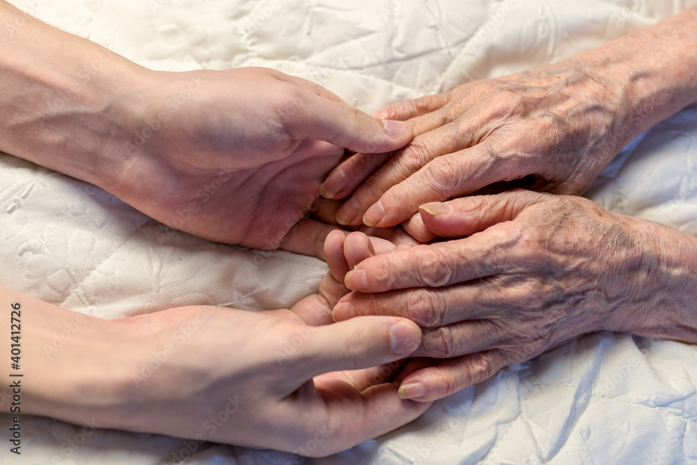 Old and young hands. Hands of an old woman-82 years in the young hands of a grandson. Old and young hands. Hands of an old woman-82 years in the young hands of a grandson.