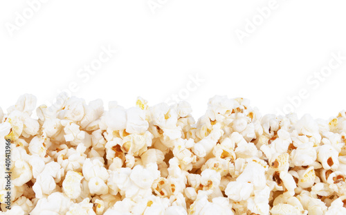 Closeup of tasty popcorn border, isolated on white background.