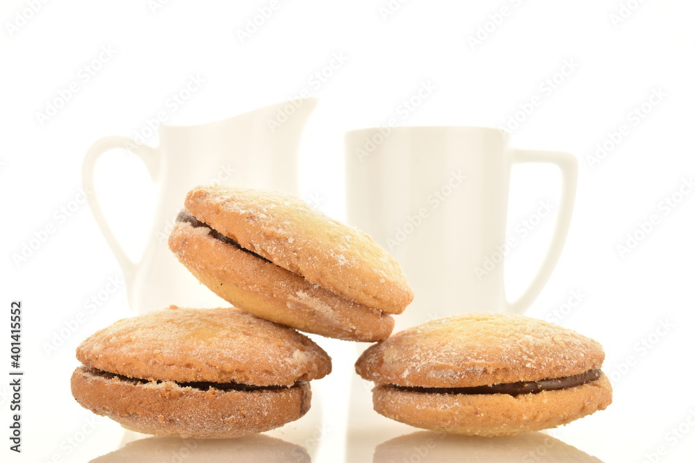 Several delicious biscotti shortbread cookies with white ceramic crockery, close-up, isolated on white. Several delicious biscotti shortbread cookies with white ceramic crockery, close-up, isolated on white.
