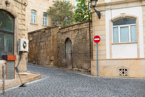 Photo of a stone street with a sign