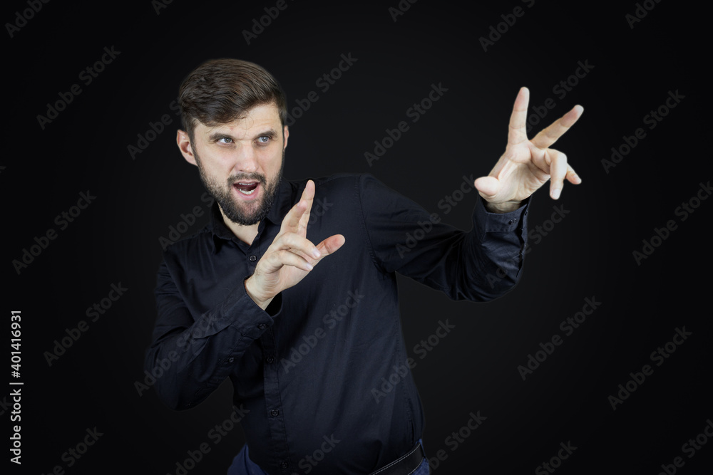 a man in a black shirt gestures with his hands a man in a black shirt gestures with his hands