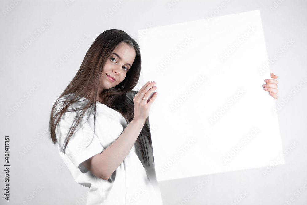 Lovely little girl kid with long hair holds empty banner Lovely little girl kid with long hair holds empty banner