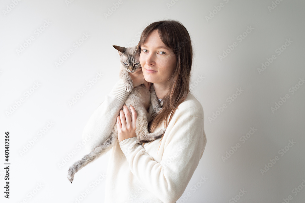 portrait of a woman with a white devon rex cat portrait of a woman with a white devon rex cat