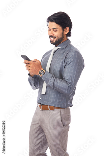 Young businessman using Cell Phone on white.