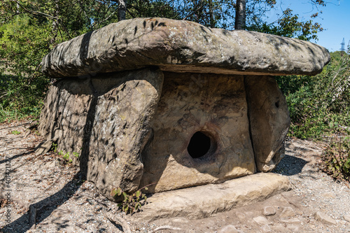 A large stone dolmen with a round entrance