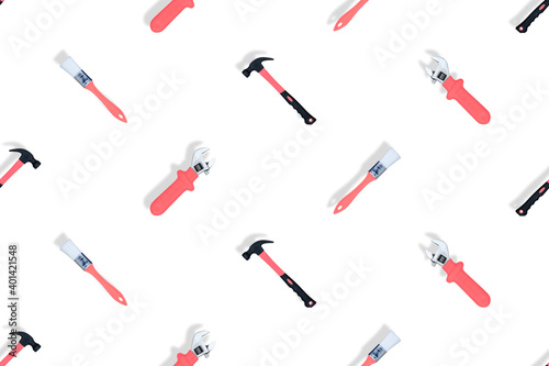 Tools seamless pattern. Tools: construction brushes, hammer, wrench on a white background.