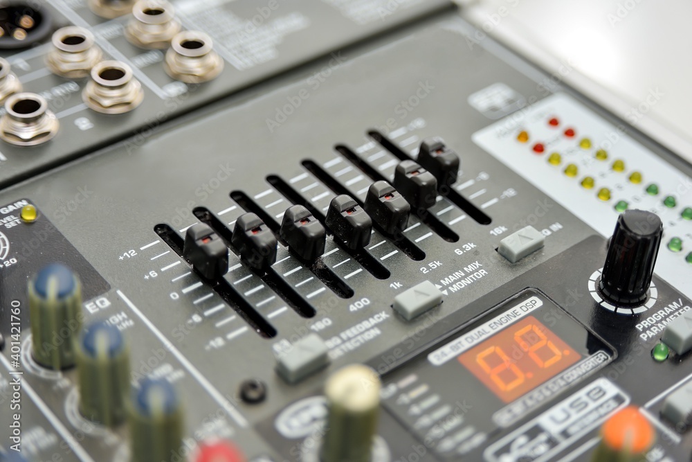 Black equalizer on a mixing console, close-up. Black equalizer on a mixing console, close-up.