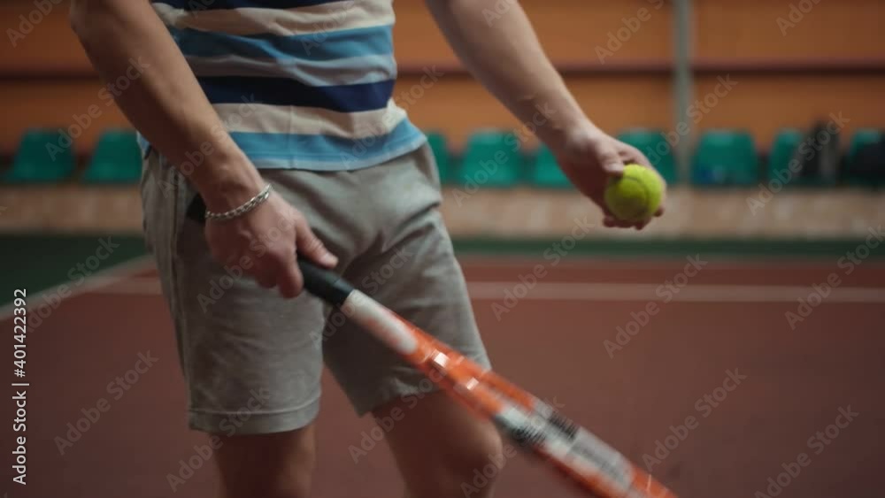 A tough guy hits a tennis ball with a tennis racket. Slow motion Stock