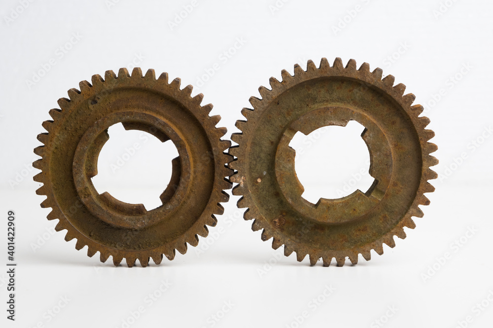 Rusty gears from an old mechanism on a white background, photographed up close. Rusty gears from an old mechanism on a white background, photographed up close.
