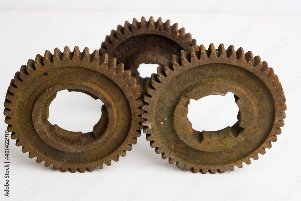 Rusty gears from an old mechanism on a white background, photographed up close. Rusty gears from an old mechanism on a white background, photographed up close.