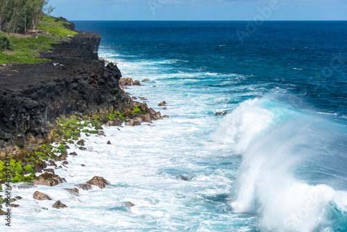 Wave crashing on a tropical and volcanic cape of Cape Mechant in Reunion island, France. photo