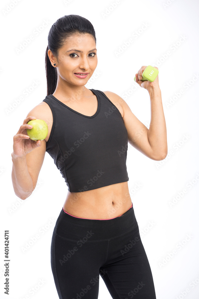 Healthy Indian woman with dumbbells working out on white background. fitness gym concept Healthy Indian woman with dumbbells working out on white background. fitness gym concept