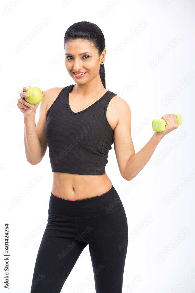 Healthy Indian woman with dumbbells working out on white background. fitness gym concept Healthy Indian woman with dumbbells working out on white background. fitness gym concept