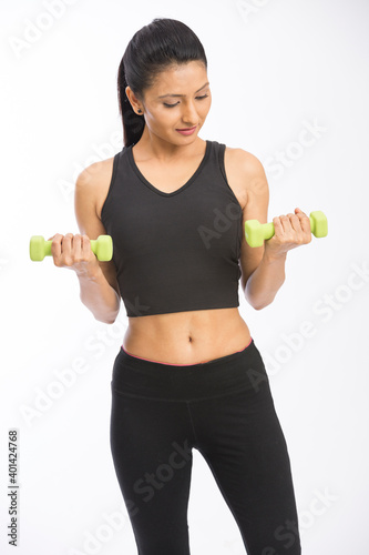Healthy Indian woman with dumbbells working out on white background. fitness gym concept