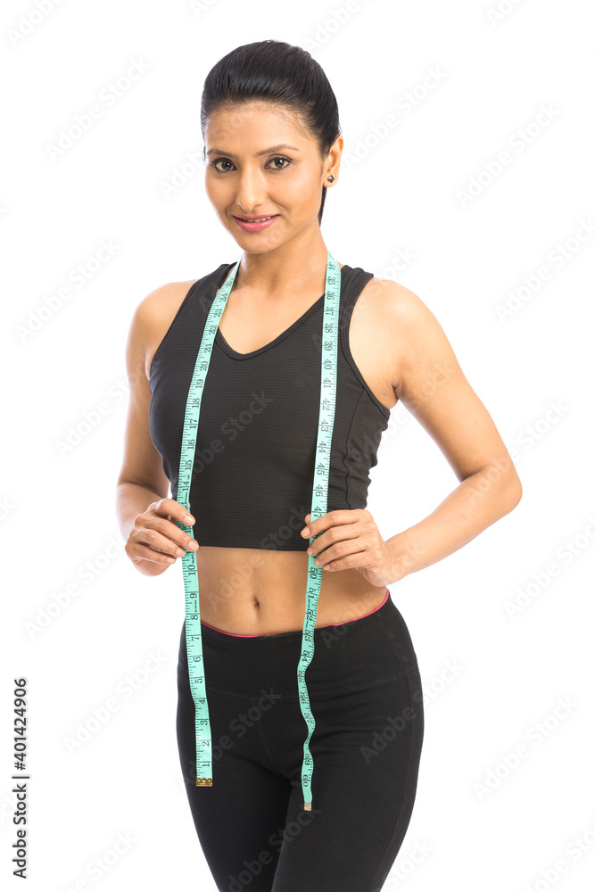 Woman posing with measuring tape over a white background Woman posing with measuring tape over a white background
