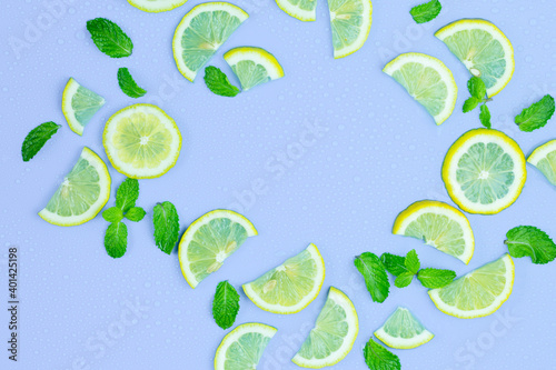 Fresh cut lemon and mint leaves on white background. Top view