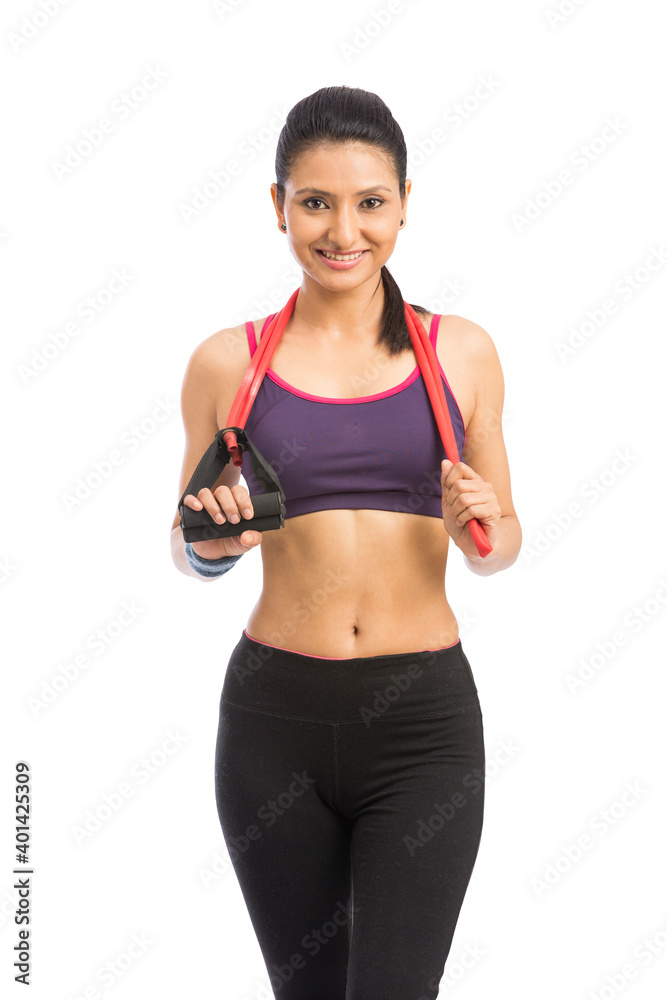 young fit women working out with rubber band over white background young fit women working out with rubber band over white background