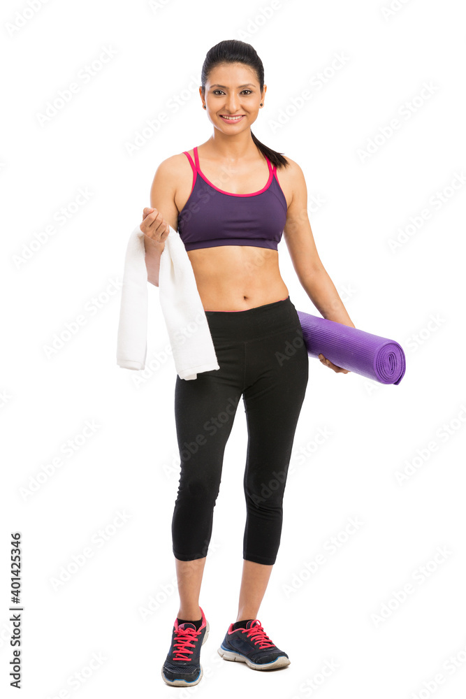 Young attractive woman holding a purple yoga mat. Isolated on white Young attractive woman holding a purple yoga mat. Isolated on white