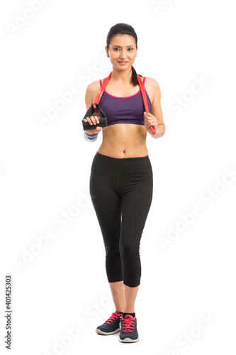 young fit women working out with rubber band over white background