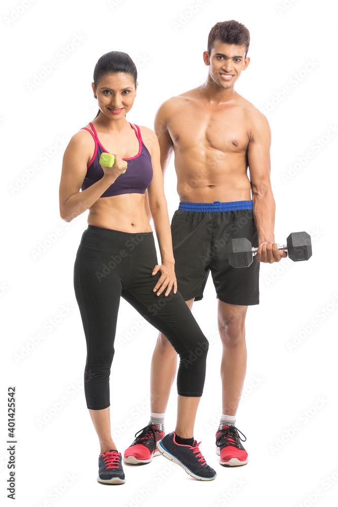Athletic man and woman with dumbbells on the white background Athletic man and woman with dumbbells on the white background