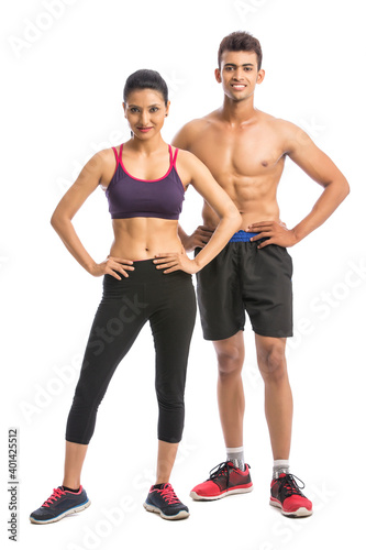 Athletic couple - man and woman after fitness exercise on the white background