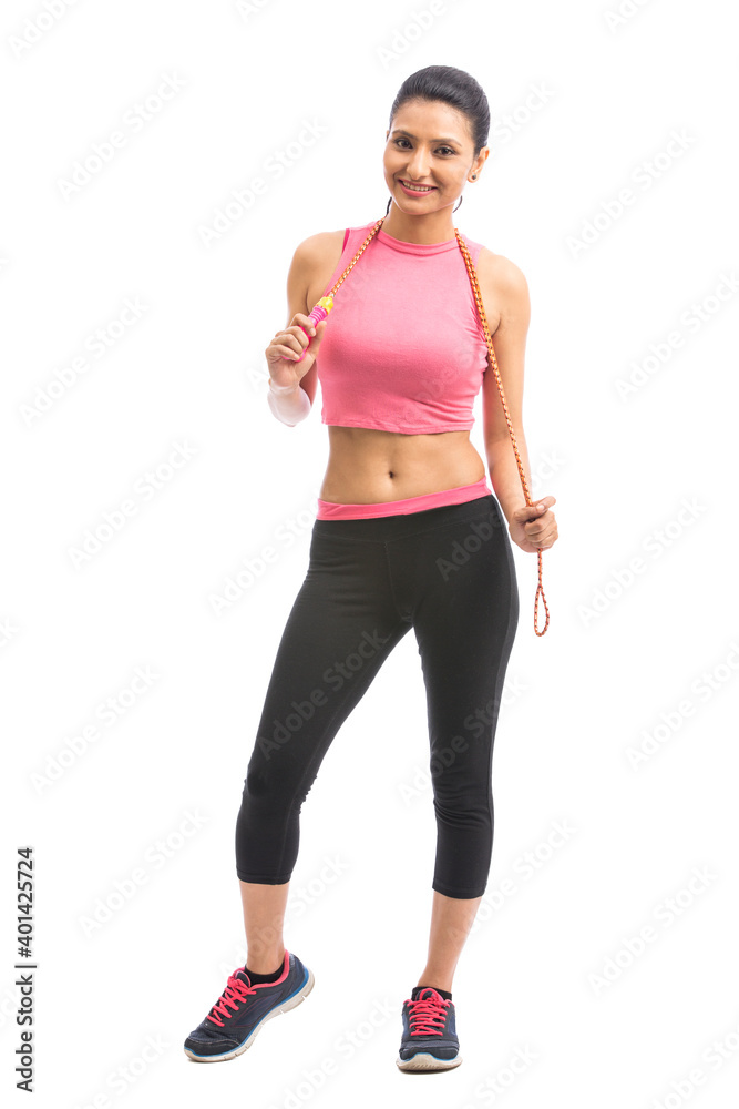 Young attractive sporty girl with skipping rope isolated Young attractive sporty girl with skipping rope isolated