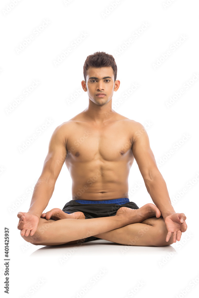 Young man is doing yoga isolated over white background Young man is doing yoga isolated over white background